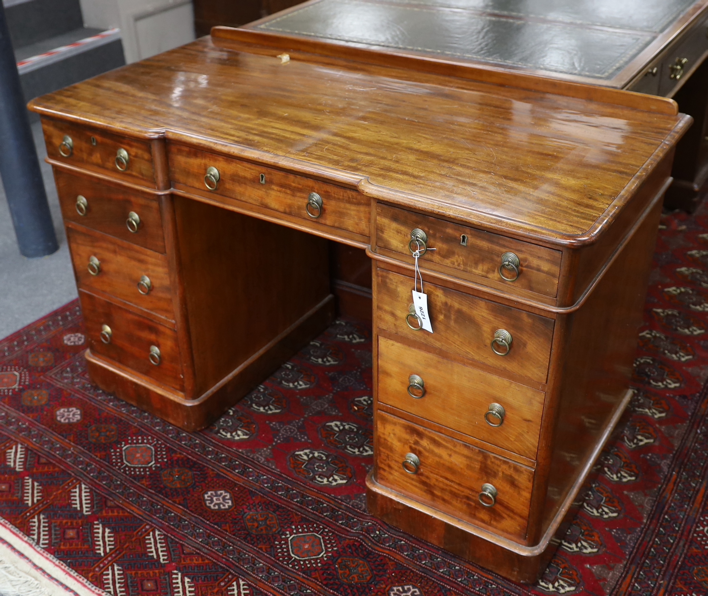A Victorian mahogany Heal & Son, London inverse breakfront pedestal desk, width 122cm, depth 59cm, height 76cm
